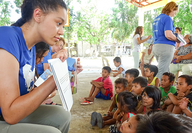 volunteer reading book to child